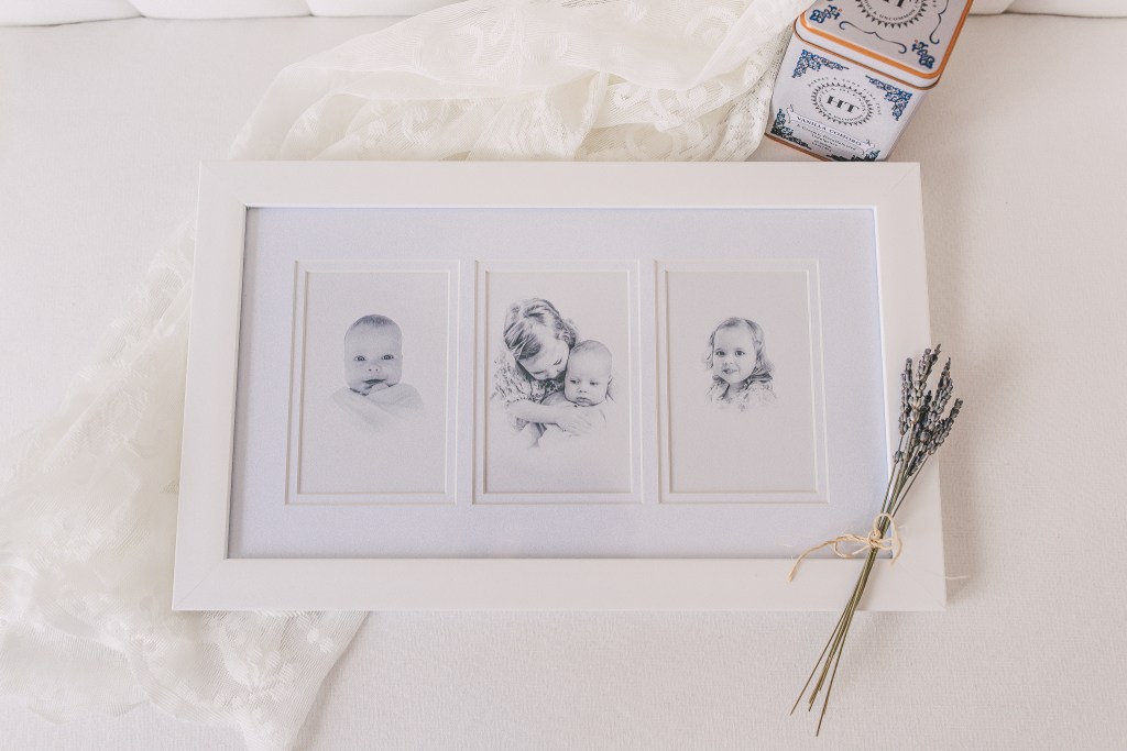 a framed photo with 3 openings showing vintage style children in black and white is laying on a piece of white lace with lavender flowers laying on the frame. Photo by Sweetly Stitched Images